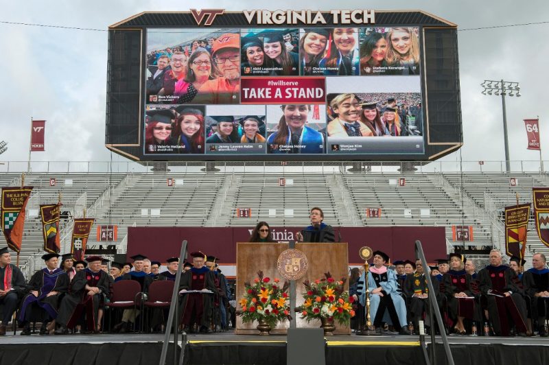 Photos using #iwillserve were featured later in the keynote commencement address as seen in a stadium video screen.