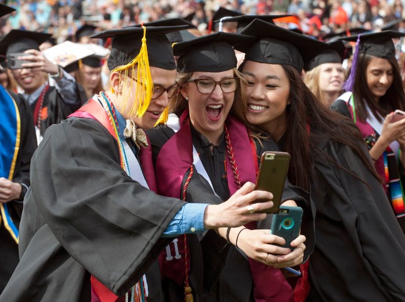 Graduates take a selfie.