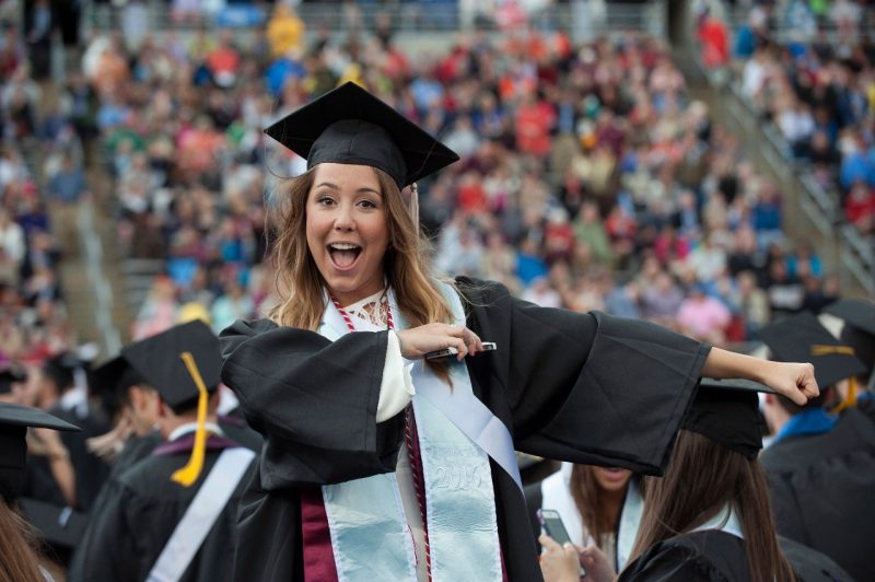 A graduate cheers at Virginia Tech's University Commencement ceremony.