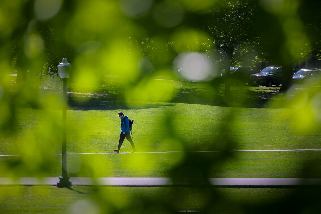A person walking across the Drillfield