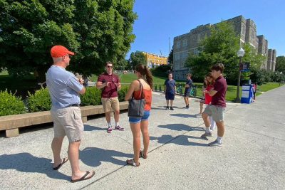 Several people stand outside on a campus tour