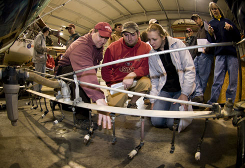 Weaver (left) shows a helicopter boom to students