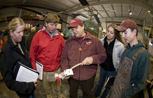 Weaver (center) shows students an atomizer nozzle.