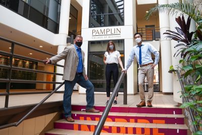 From left: Business information technology faculty member Justin Monday and students Holly Kania and Jason Kim pose in the atrium of Pamplin Hall. Photo by Justin Rocha/PRISM.