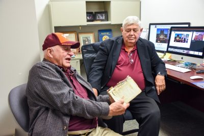 Left to right, Jay Sipes and Harry Dorn sit and reminisce in the latter's office in Davidson Hall. Jay wears all Hokie gear and a gray sports jacket. Dorn wears a blue sports jacket.Photo by Melissa Vergara for Virginia Tech.