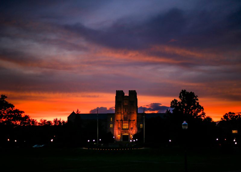 Burrus Hall appears  from the Drillfield at sunset