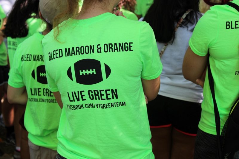 people wear bright green shirts advertising the VT green team